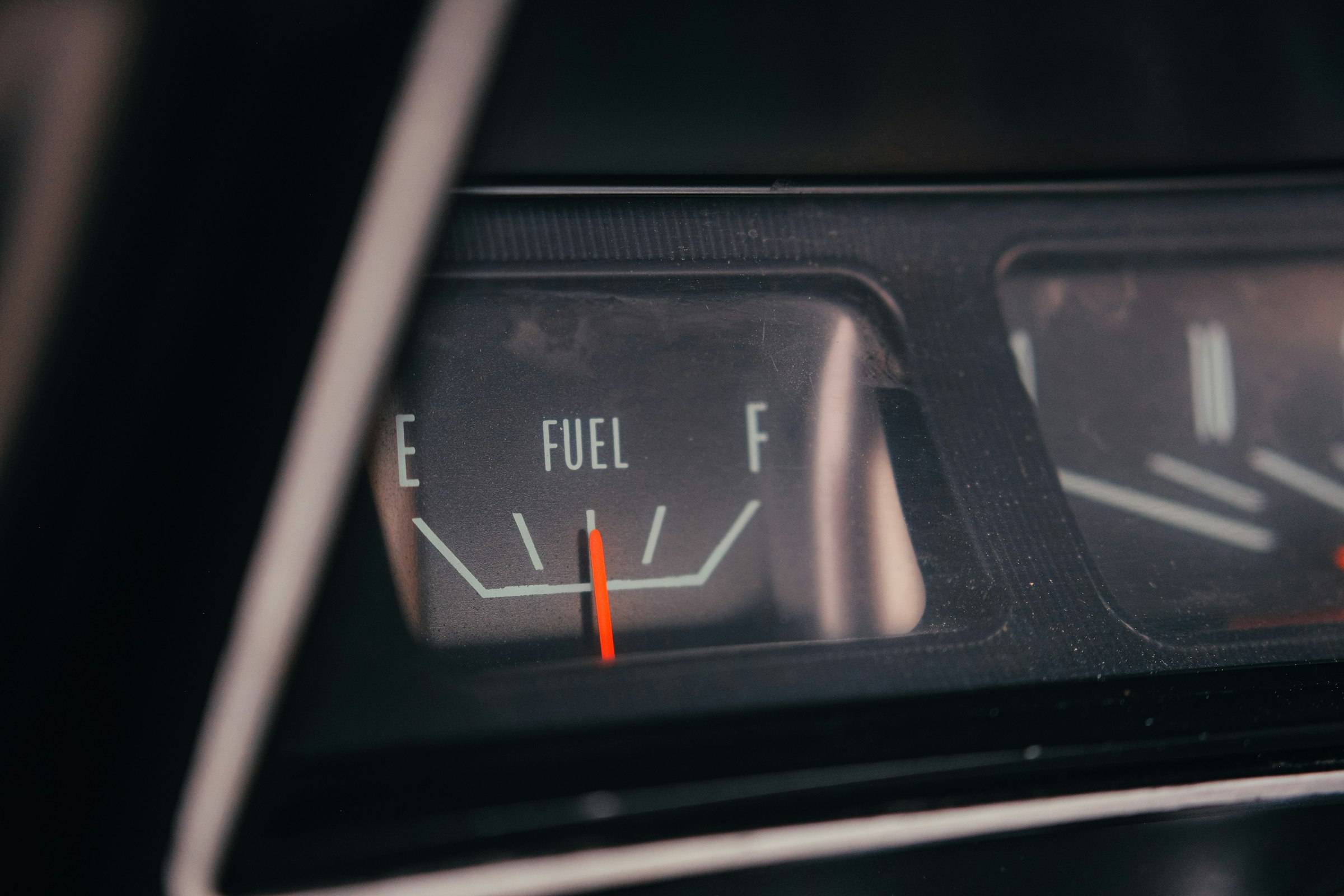 A car’s fuel gauge needle resting on empty